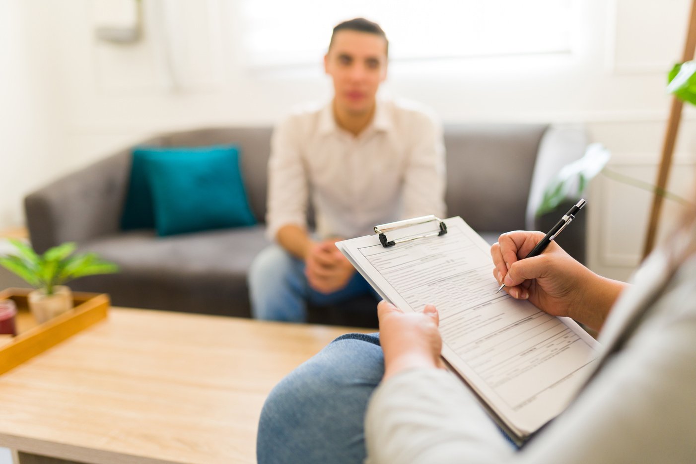 Psychologist doing a patient evaluation while talking with a man